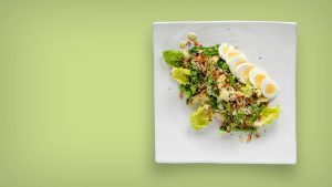 Plate of leafy greens and sliced eggs rich in folate and choline that support healthy methylation